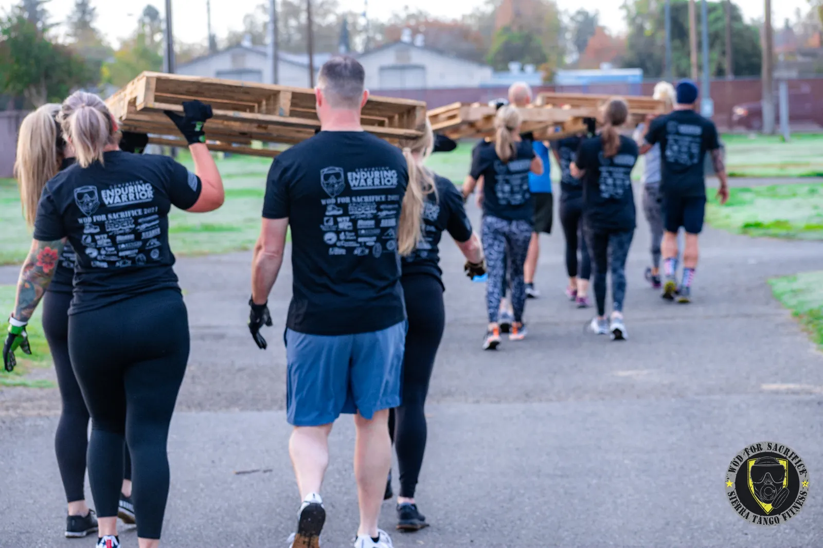Members carrying pallets at a Sierra Tango community event