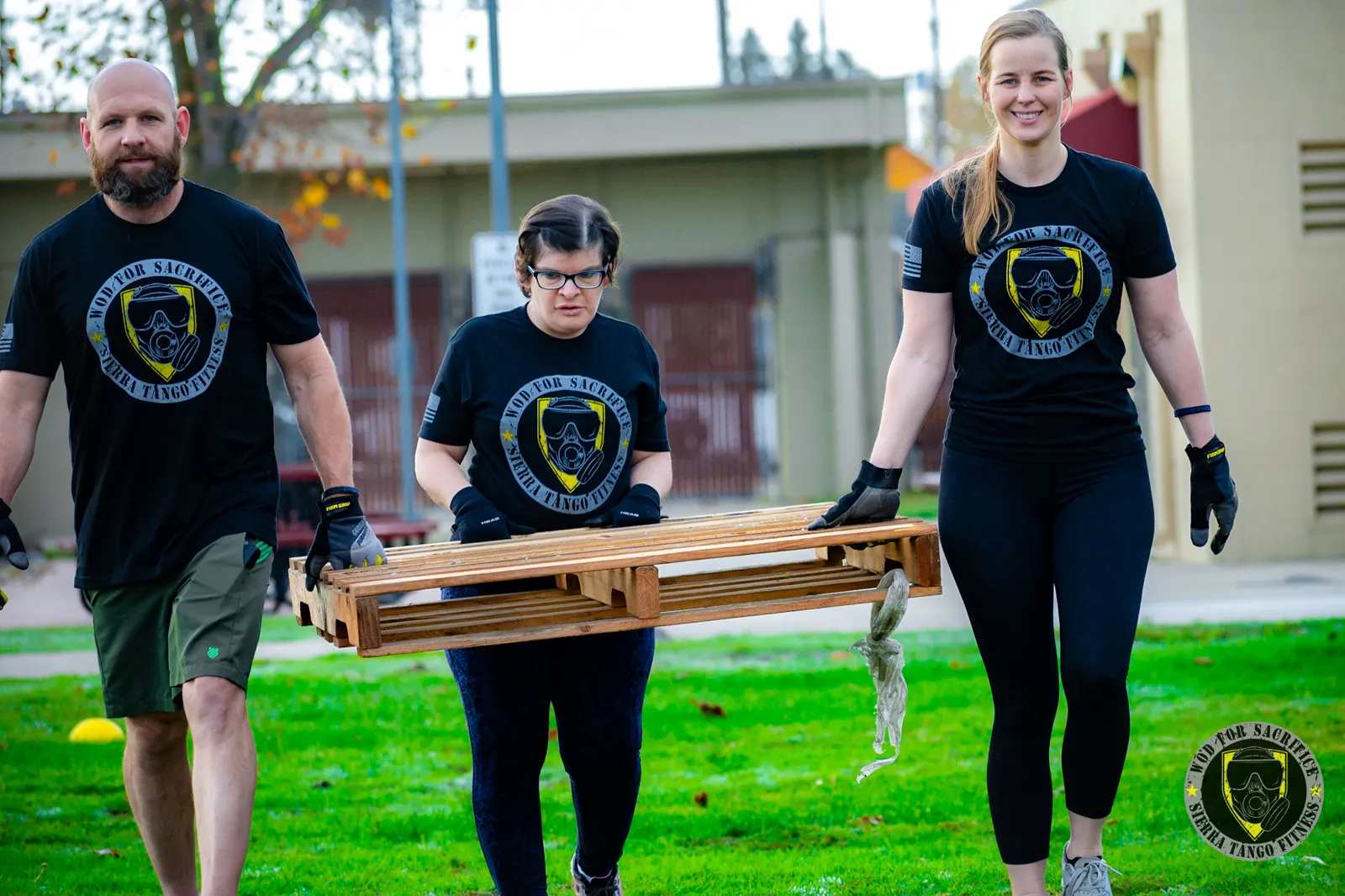 Members carrying a pallet together at a Sierra Tango event