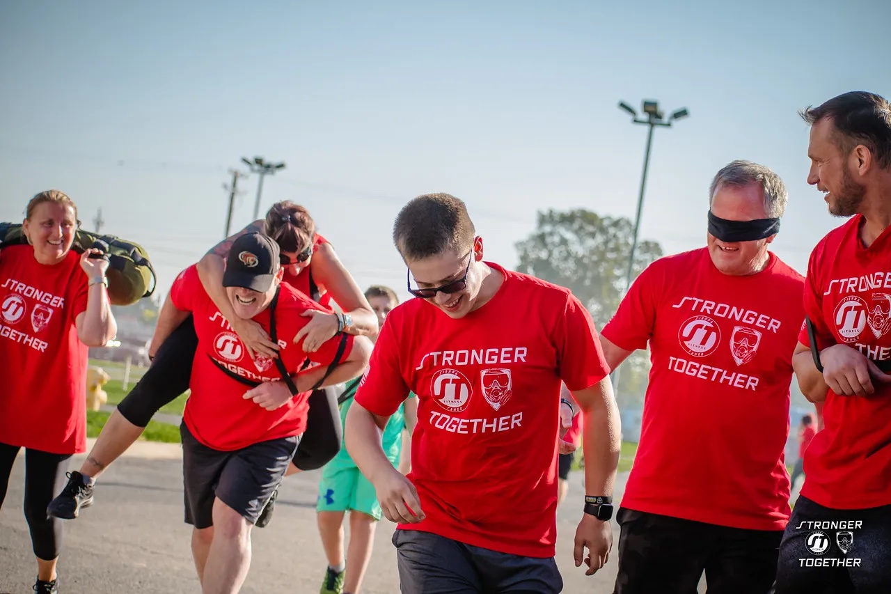 Sierra Tango members guiding a blindfolded veteran during a Stronger Together event